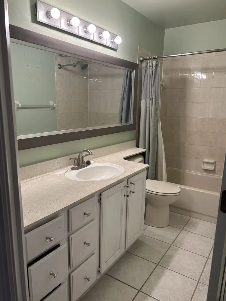 Before: Original bathroom with dated vanity and tub-shower before the remodel in Palm Harbor