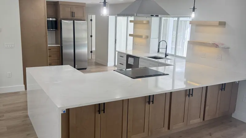 Open-concept kitchen and living space with new plank flooring in Osprey, FL