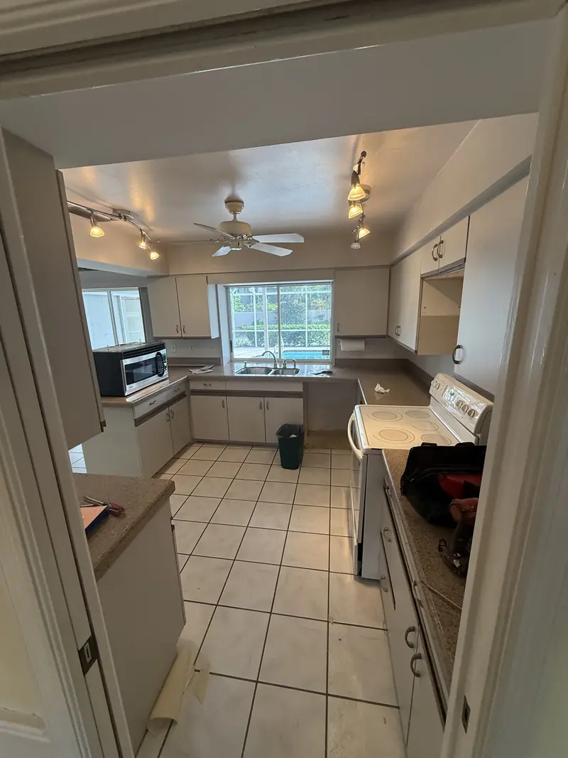 Before: Closed-in galley kitchen with tile floor before it was opened up in Osprey, FL