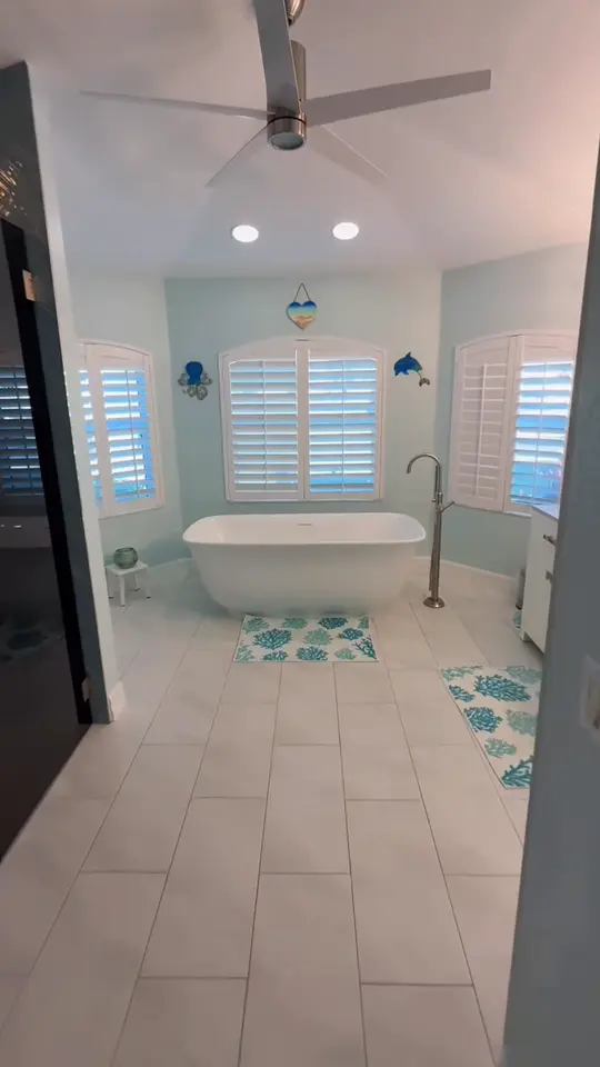 Bathroom transformation: An outdated bathroom stripped to the studs and rebuilt with a herringbone tile shower, a freestanding tub and a cleaner layout.