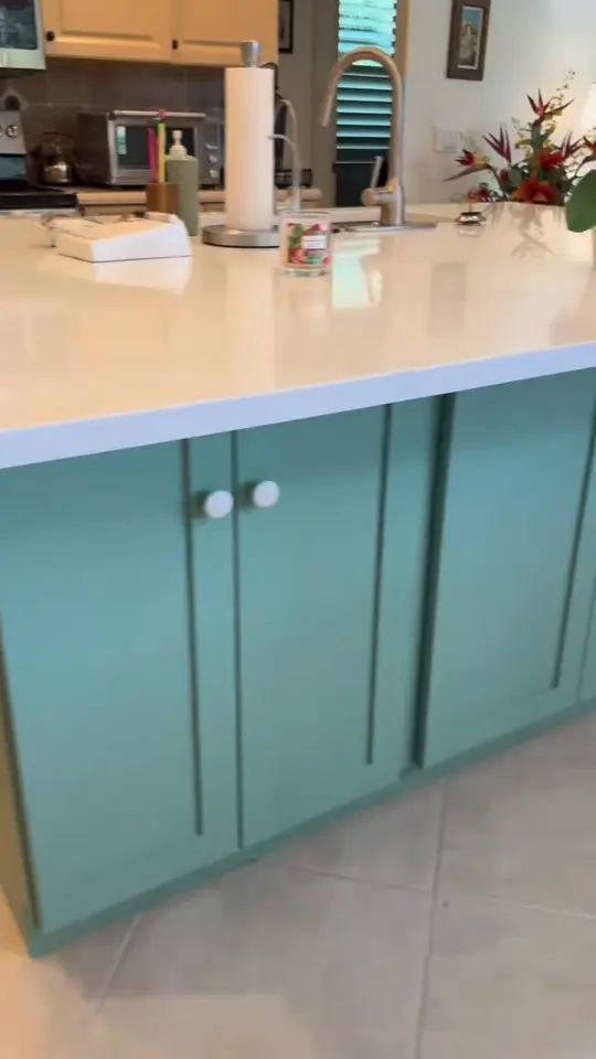 Kitchen island and custom cabinets: A new quartz-topped island and matching custom cabinets, with the homeowner describing how the project went.