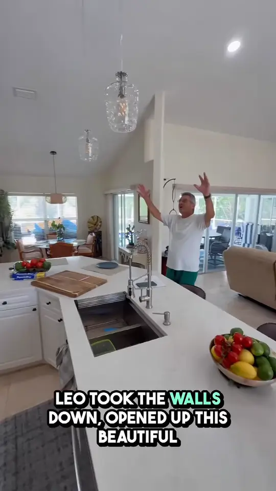 Open kitchen with a quartz island: The homeowner shows how walls came down to open the kitchen, with a new quartz countertop, appliances and flooring.